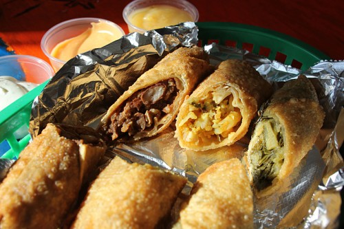 Jerk chicken, mac and cheese and greens egg rolls with dipping sauces