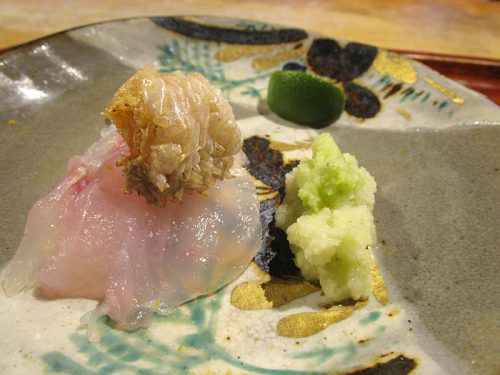 Fish (bonito, perhaps, since it's seared) with its own skin crisped on top