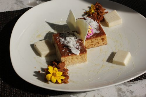 Pastry chef Erika Tomei's tribute to the honey harvested on property: tres leches honey cake, B. honey, dehydrated milk foam, honey-oatmeal crumble, white chocolate "honey comb," edible flowers